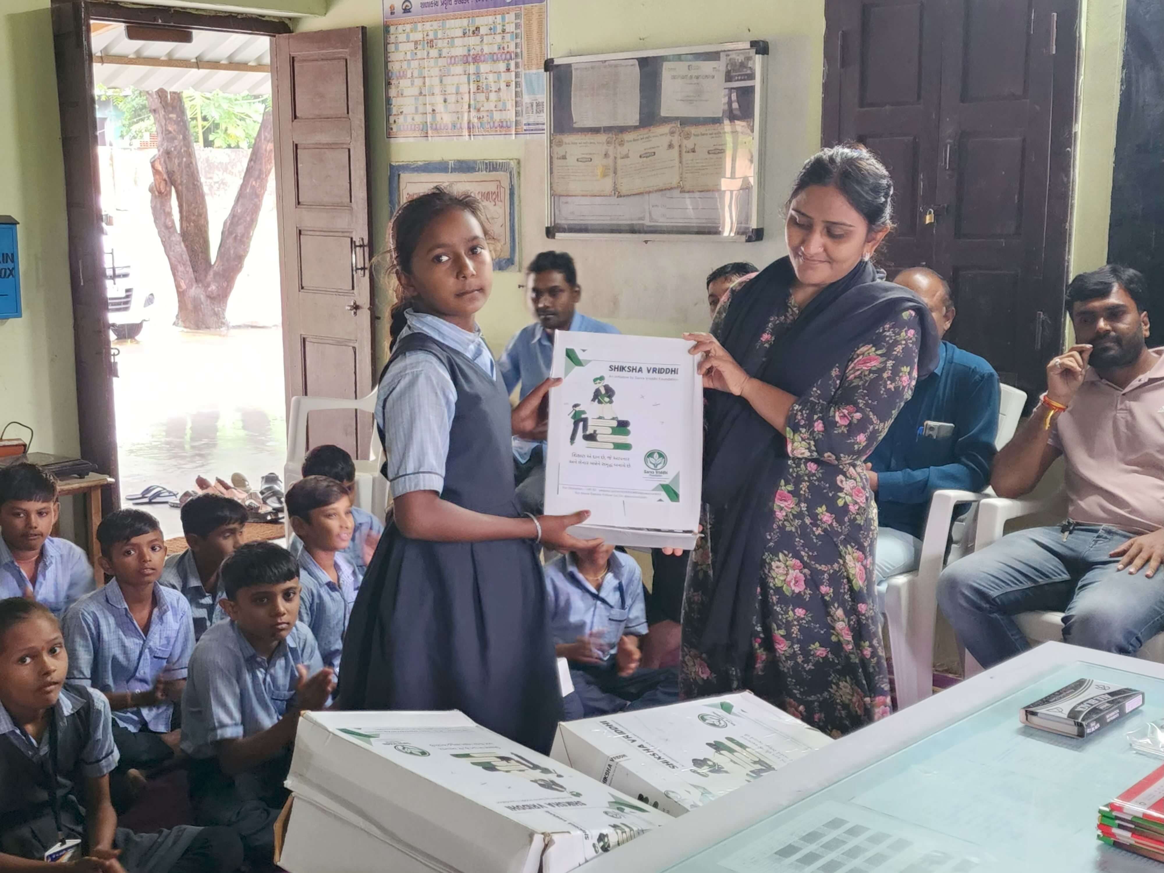 Child receiving an educational kit in 2025